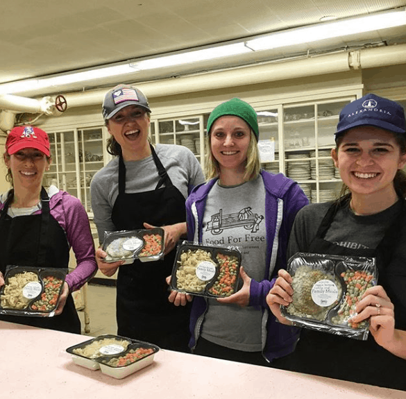 Volunteers and staff show off meals they have created